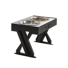 Ladda upp bild till gallerivisning, Stylish black pet feeding station with two stainless steel bowls, featuring paw print design and a sturdy X-shaped support that can be adjusted according to the pet's growth